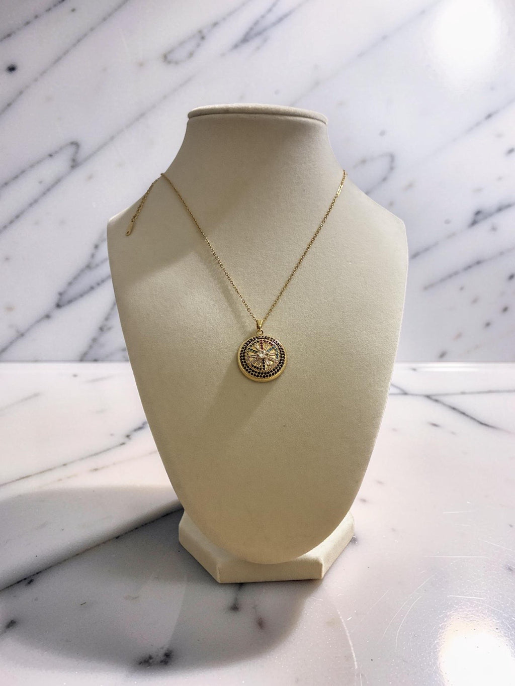 Gold plated circular evil eye pendant with zirconia stones