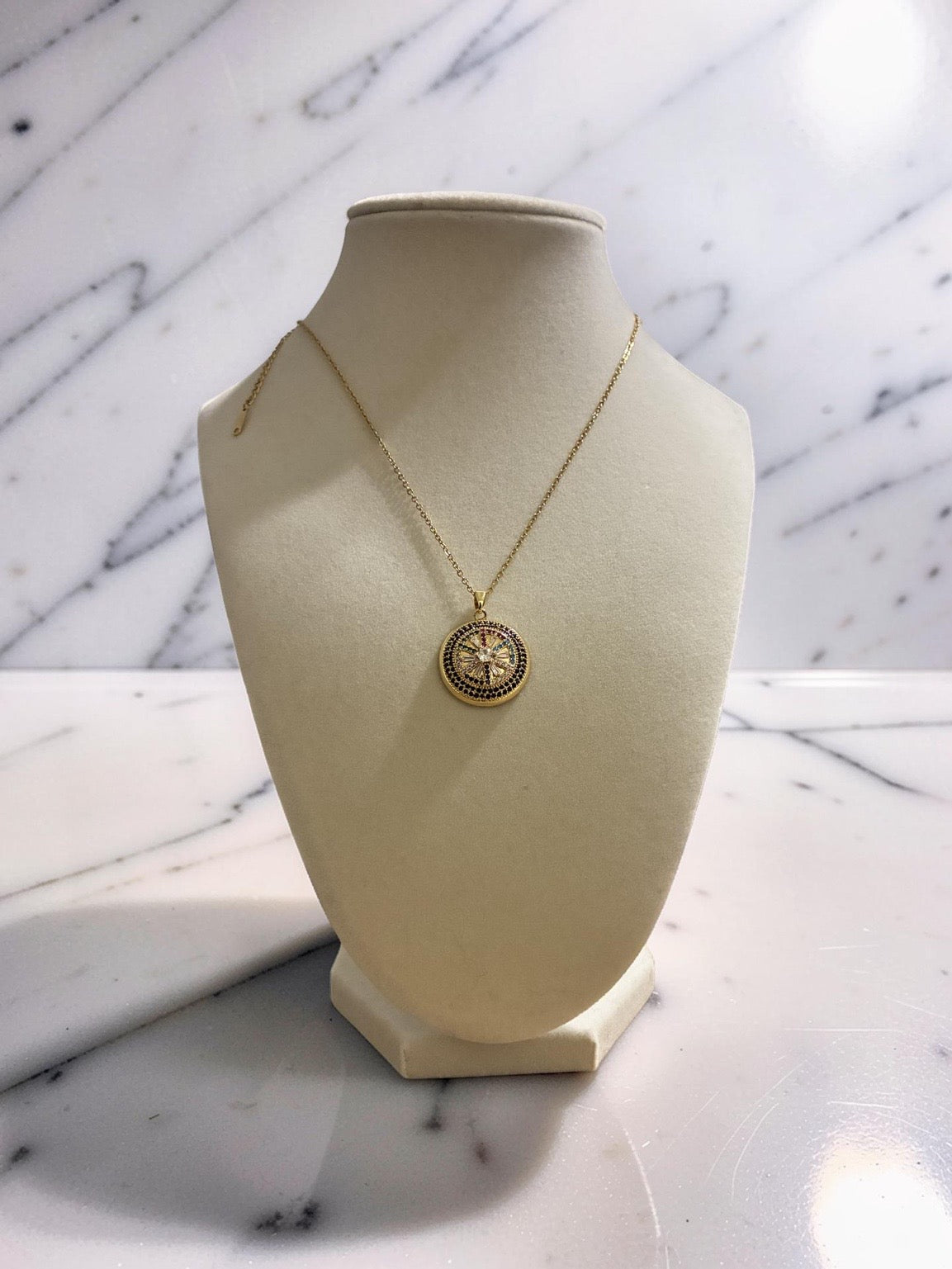 Gold plated circular evil eye pendant with zirconia stones