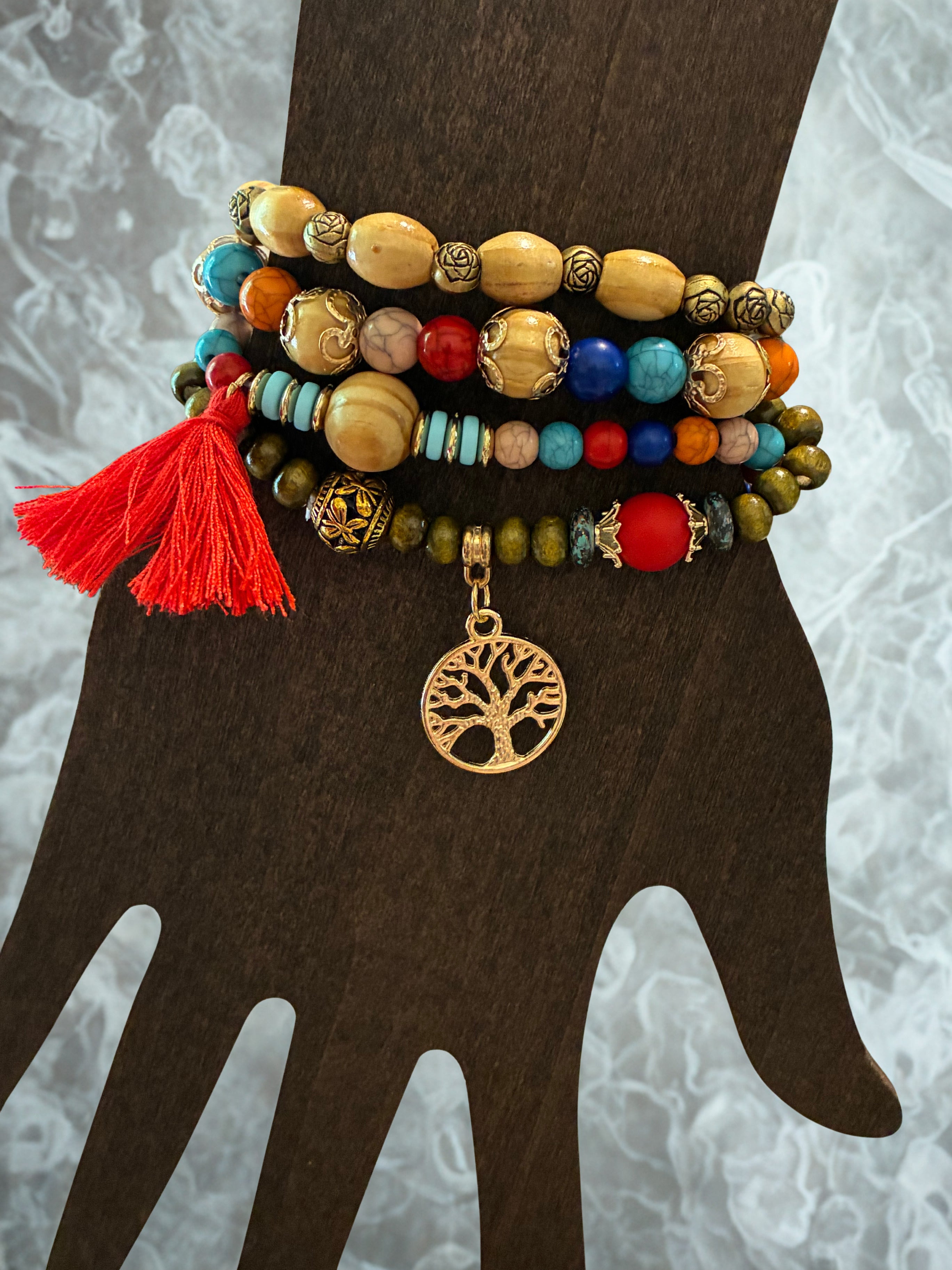 Set of 4 colorful beaded bracelets with charm and tassel ￼
