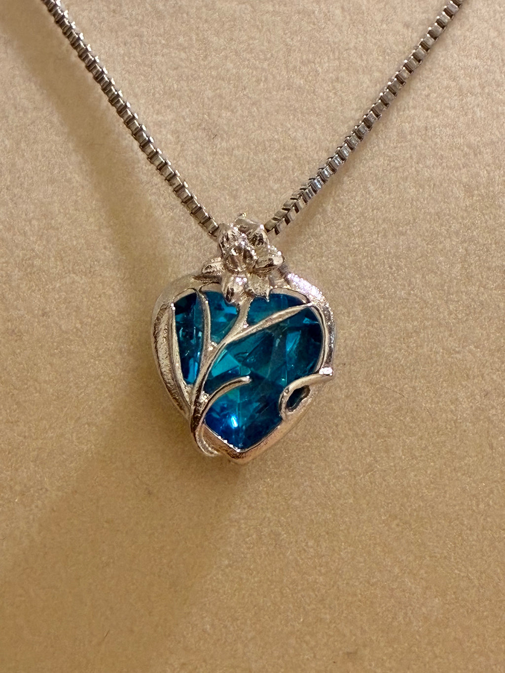 Sterling silver pendant with a blue crystal heart