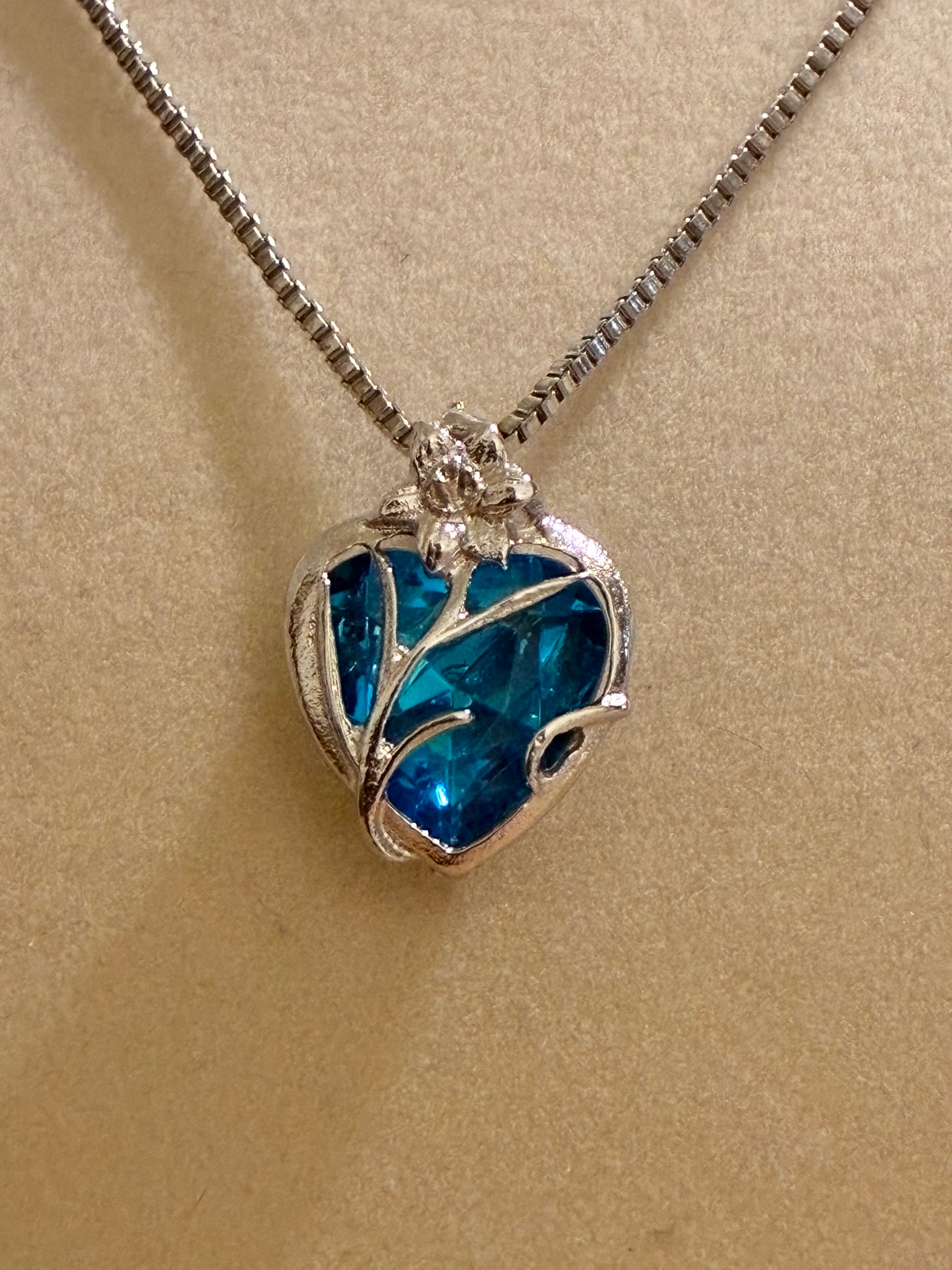 Sterling silver pendant with a blue crystal heart