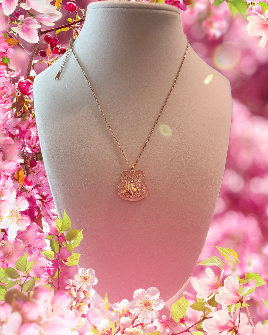 Stainless steel, gold plated, bunny pendant with flower and rhinestones ￼