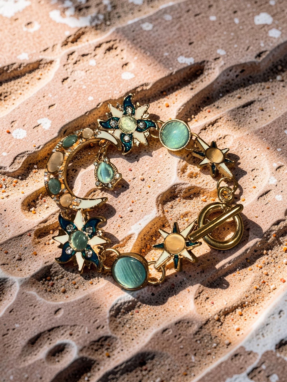 Gold plated, multicolored stones, suns and moons