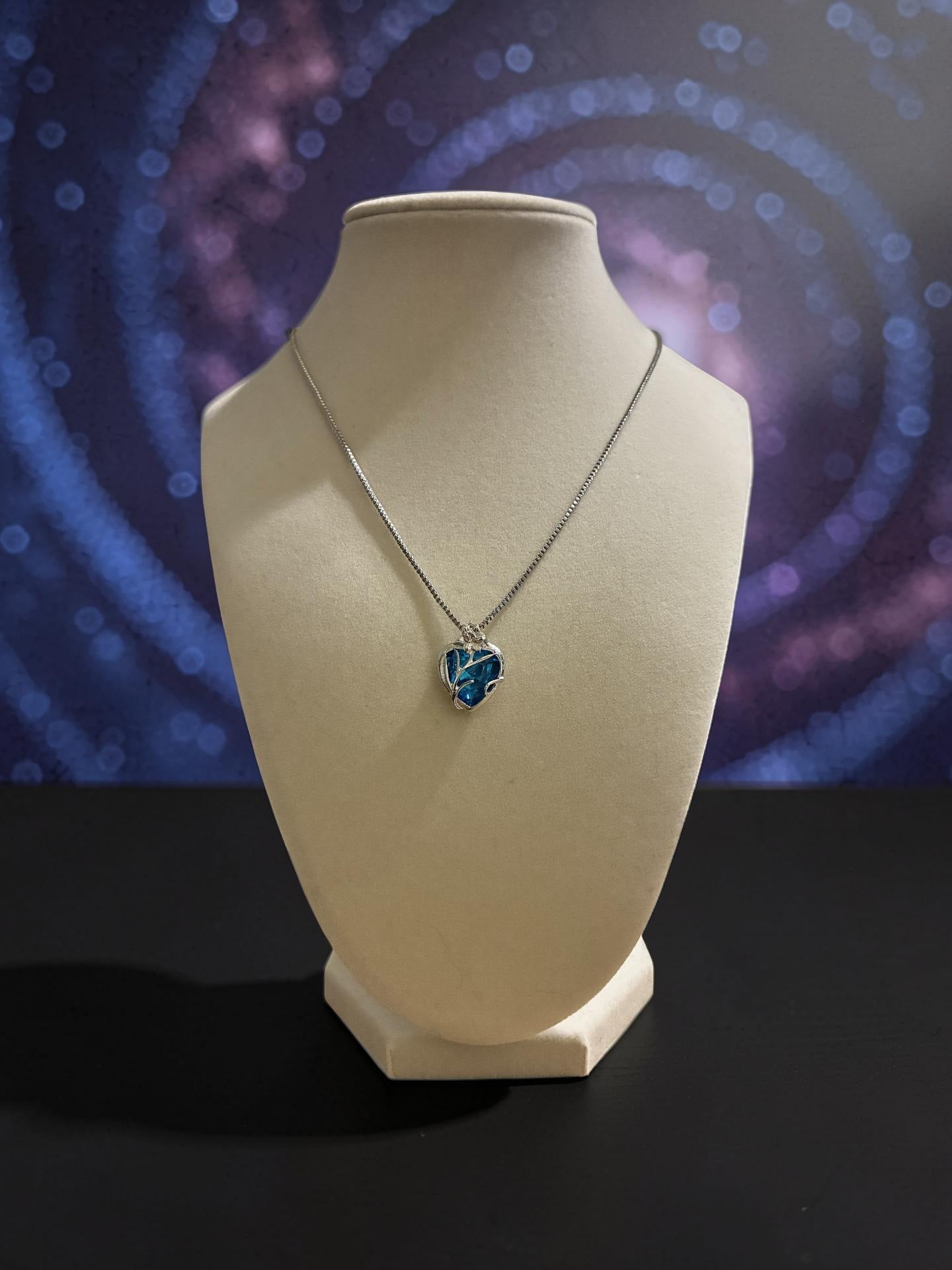 Sterling silver pendant with a blue crystal heart