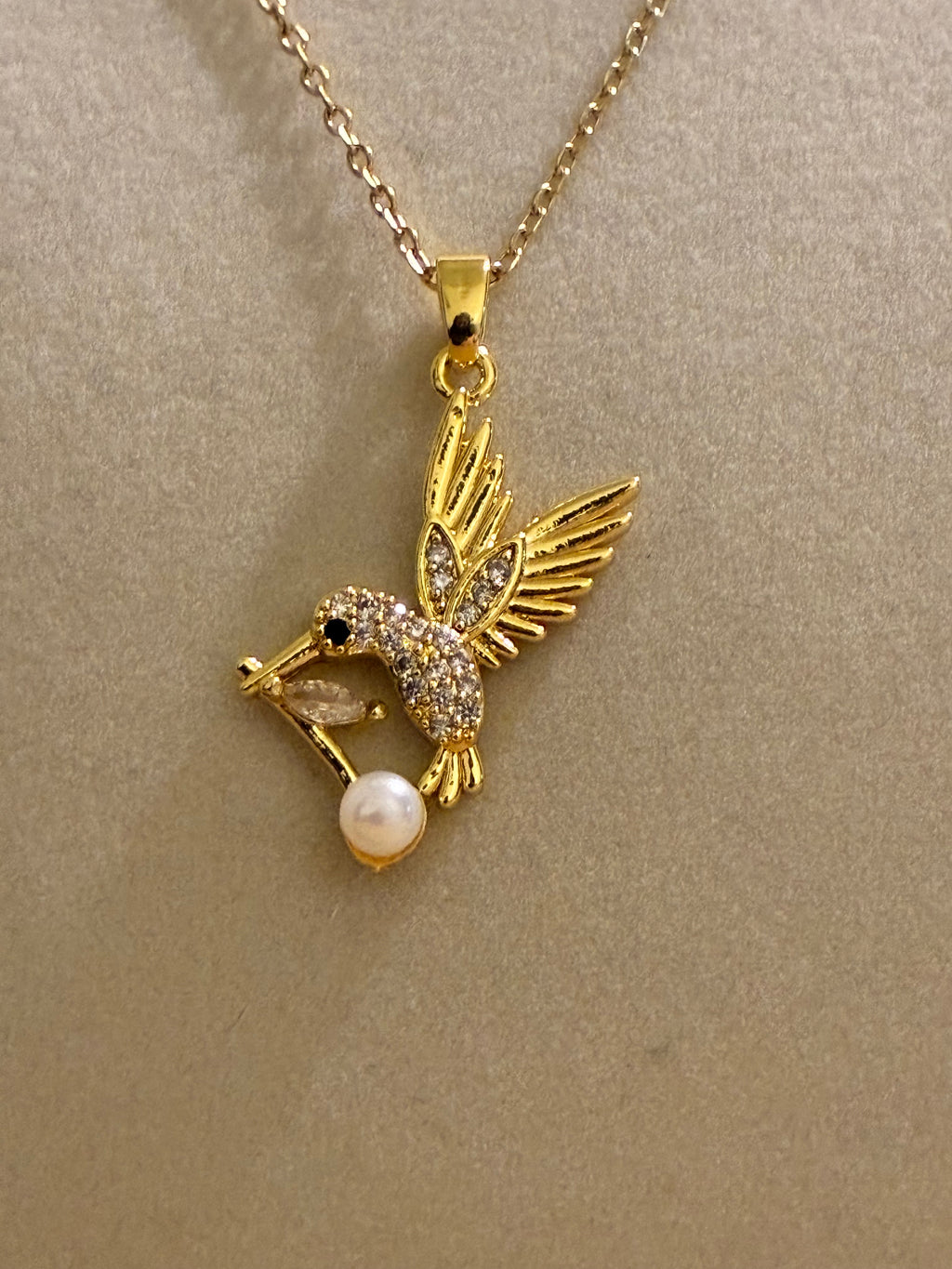 Stainless steel gold plated hummingbird with rhinestones and pearl