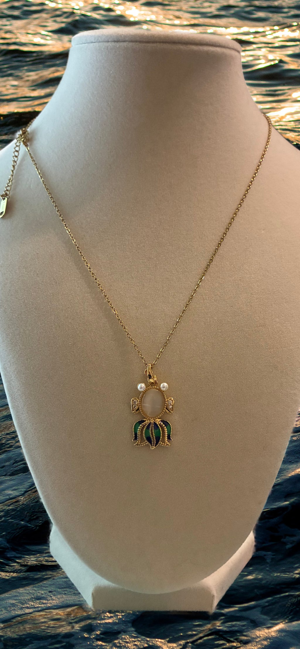 Stainless steel, gold plated, fish with moonstone, pearl eyes and rhinestones
