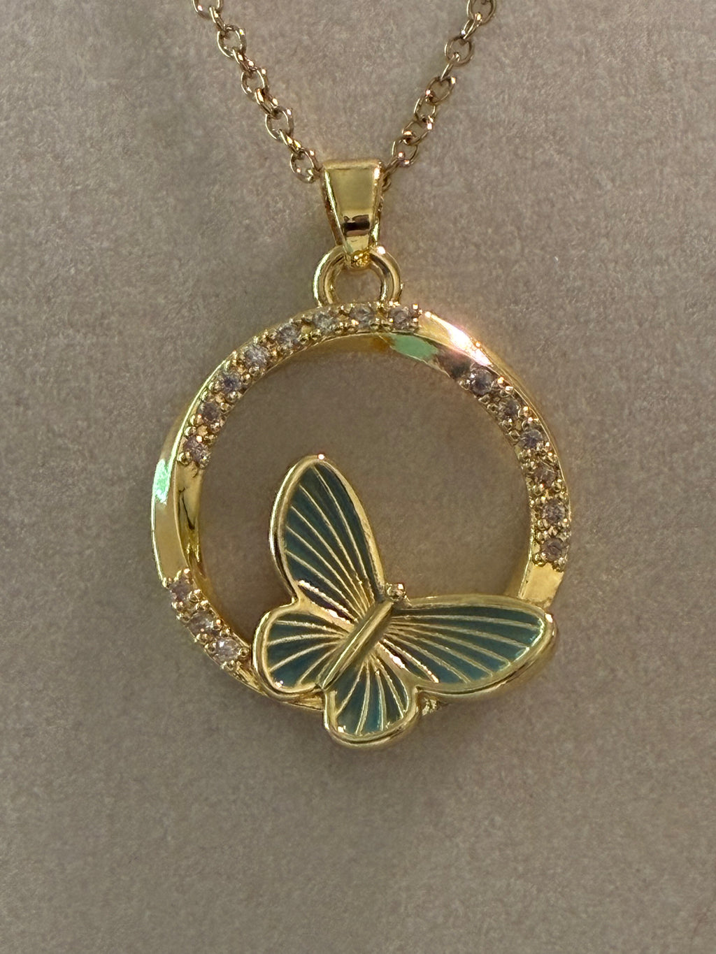 Stainless steel, gold plated, green butterfly with rhinestones